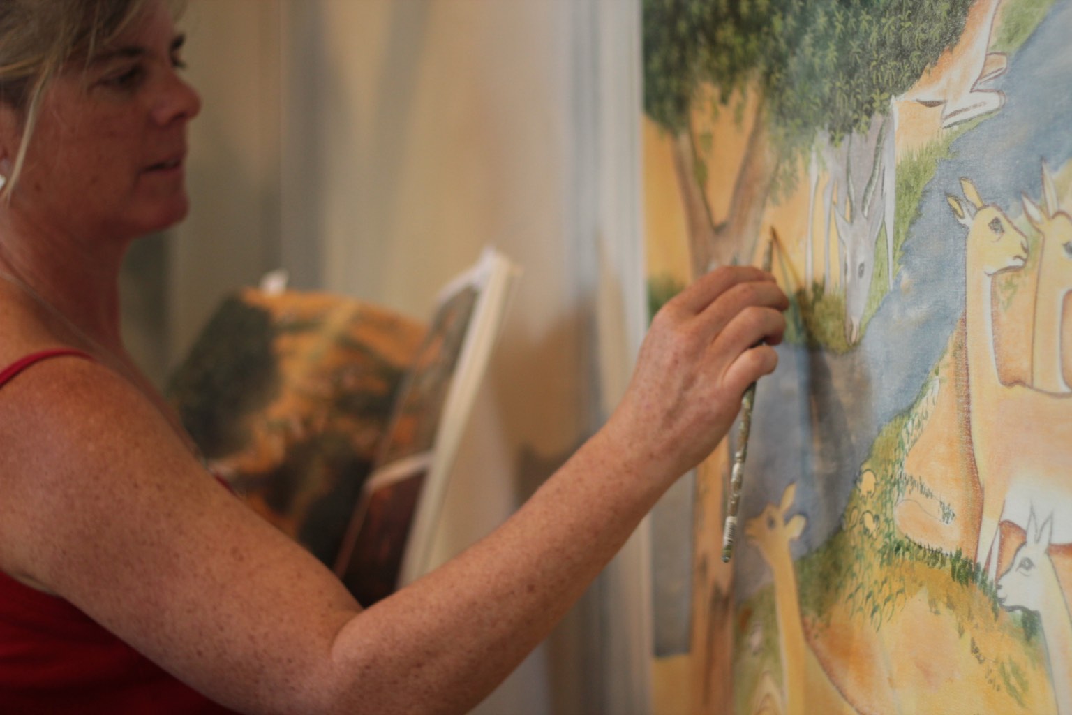 Woman painting a wall